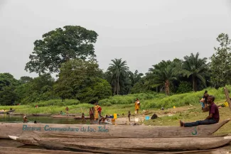 Boat and people by the river